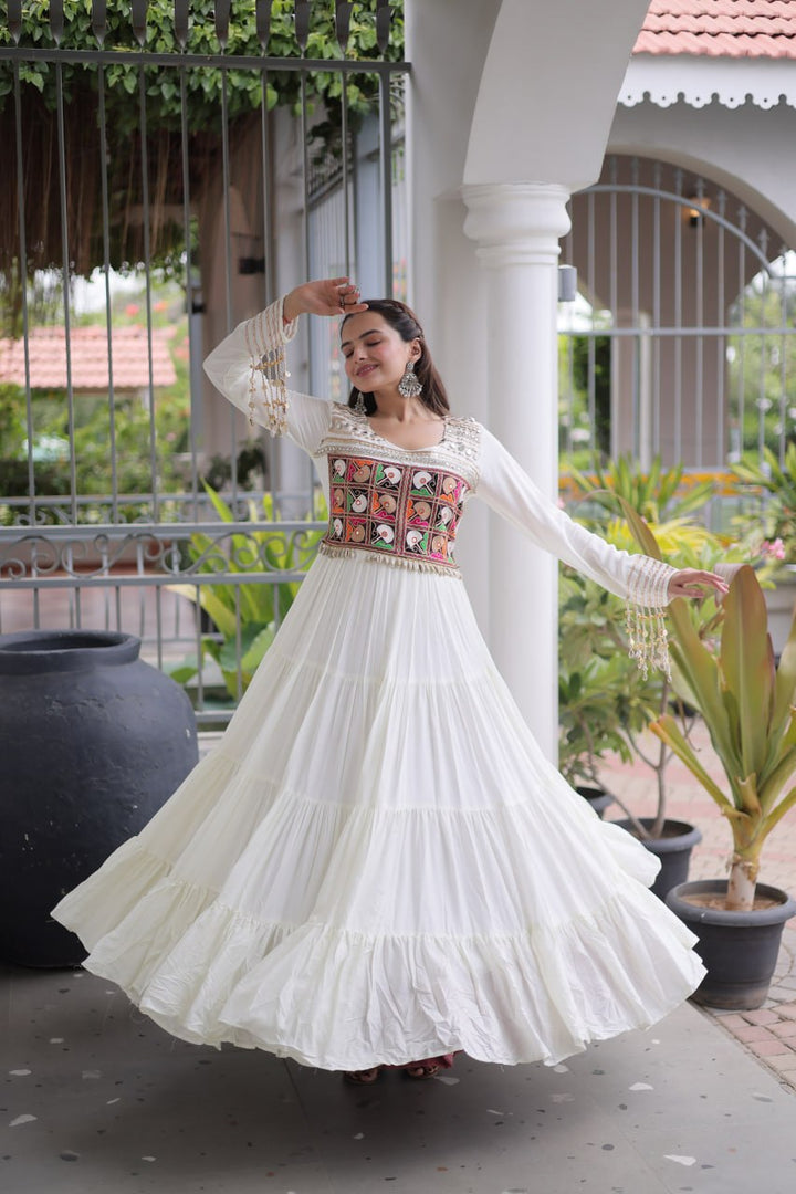 This White, Maroon & Black Colored Attractive Navratri Special Gown will surely fetch you compliments for your rich sense of style, Grab this gown before someone else gets it and wear it.